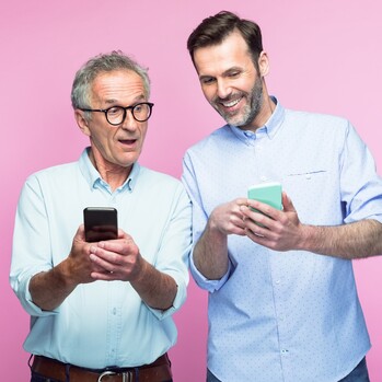 old and young man looking at smartphones